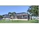 This home has a screened-in patio and backyard on a sunny day at 5497 56Th E Ct, Bradenton, FL 34203