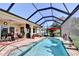 Stunning pool with screened enclosure, outdoor dining, and lush landscaping at 5497 56Th E Ct, Bradenton, FL 34203