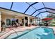 Beautiful pool area with screened lanai, outdoor seating, and lush backyard views at 5497 56Th E Ct, Bradenton, FL 34203