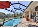 Amazing outdoor pool area with screened-in lanai, patio furniture, and water view at 5497 56Th E Ct, Bradenton, FL 34203