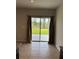 Bright room showcasing a glass sliding door leading to the lush backyard at 17130 11Th Ter E, Bradenton, FL 34212