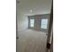 Cozy bedroom features neutral walls, carpet flooring, and dual windows for natural light at 17130 11Th Ter E, Bradenton, FL 34212