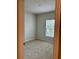 A cozy carpeted bedroom features neutral walls and a bright window at 17130 11Th Ter E, Bradenton, FL 34212