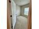 Cozy bedroom featuring neutral carpet, light walls, and a bright window with blinds at 17130 11Th Ter E, Bradenton, FL 34212