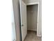 A closet with a white door and a white wire rack and beige walls at 17130 11Th Ter E, Bradenton, FL 34212