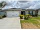 Charming single-story home featuring a two-car garage, well-maintained lawn, and fresh landscaping at 17130 11Th Ter E, Bradenton, FL 34212