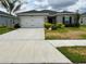 Charming single-story home featuring a two-car garage, well-maintained lawn, and fresh landscaping at 17130 11Th Ter E, Bradenton, FL 34212