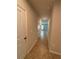 Hallway with tiled flooring, neutral walls, and doors leading to other rooms in the house at 17130 11Th Ter E, Bradenton, FL 34212