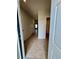 Bright hallway featuring neutral walls, tile flooring, and doorways leading to other rooms in the house at 17130 11Th Ter E, Bradenton, FL 34212