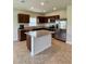 Modern kitchen with granite countertops, an island, stainless steel appliances, and dark cabinets at 17130 11Th Ter E, Bradenton, FL 34212