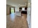 Open-concept kitchen featuring tile floors, an island, dark cabinets, stainless appliances, and sliding doors to the yard at 17130 11Th Ter E, Bradenton, FL 34212