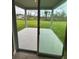 View through sliding glass doors to a covered patio and backyard at 17130 11Th Ter E, Bradenton, FL 34212