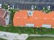 Aerial view of a condo complex featuring terra cotta roofs, surrounded by lush landscaping and ample parking at 6151 Bahia Del Mar Blvd # 125, St Petersburg, FL 33715