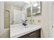 Bathroom with a sink and vanity with a full mirror, adjacent to the glass enclosed shower at 6151 Bahia Del Mar Blvd # 125, St Petersburg, FL 33715