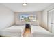 Bedroom with twin beds, light wood flooring, and a window view of the neighborhood at 6151 Bahia Del Mar Blvd # 125, St Petersburg, FL 33715