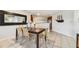 Cozy dining area with tile flooring, a dark table, straw chairs, and modern decor at 6151 Bahia Del Mar Blvd # 125, St Petersburg, FL 33715
