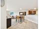 Dining area with tile flooring, a dark table, straw chairs, and modern decor at 6151 Bahia Del Mar Blvd # 125, St Petersburg, FL 33715