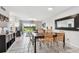 Bright dining area featuring sliding doors to a patio, tiled floor, and modern furnishings at 6151 Bahia Del Mar Blvd # 125, St Petersburg, FL 33715