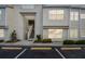 Beige condo building featuring reserved parking, stairs to upper units, and tidy landscaping at 6151 Bahia Del Mar Blvd # 125, St Petersburg, FL 33715