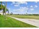 Scenic view of a golf course with manicured fairways, palm trees, and residential buildings at 6151 Bahia Del Mar Blvd # 125, St Petersburg, FL 33715