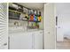 Laundry room featuring a washer and dryer, with shelving for storage, and closet doors at 6151 Bahia Del Mar Blvd # 125, St Petersburg, FL 33715