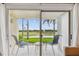 A patio with two chairs and a table, overlooking a golf course at 6151 Bahia Del Mar Blvd # 125, St Petersburg, FL 33715