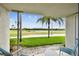 Patio view overlooking a well-manicured golf course with palm trees and a pond at 6151 Bahia Del Mar Blvd # 125, St Petersburg, FL 33715