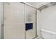 Close-up of a shower with textured glass doors, chrome frame, and towel rack at 6151 Bahia Del Mar Blvd # 125, St Petersburg, FL 33715