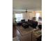 Comfortable living room with stylish brown sectional, area rug, and lots of natural light at 9871 Trumpet Vine Loop, Trinity, FL 34655