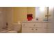 Bright bathroom with a toilet, shower and vanity with white cabinets and silver hardware at 10308 Soaring Eagle Dr, Riverview, FL 33578