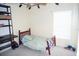 Neutral bedroom with wood bed frame, a ceiling fan, and natural light from window at 10308 Soaring Eagle Dr, Riverview, FL 33578