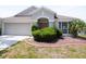 Inviting home exterior featuring a well-maintained lawn, inviting front entrance and two-car garage at 10308 Soaring Eagle Dr, Riverview, FL 33578