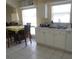 Eat-in kitchen has double stainless steel sink, white cabinets and dishwasher at 10308 Soaring Eagle Dr, Riverview, FL 33578