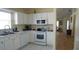 Bright kitchen with white cabinets and appliances at 10308 Soaring Eagle Dr, Riverview, FL 33578