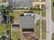 A detailed aerial view of the home featuring a backyard with a storage shed and an extended driveway at 4408 W Prescott St, Tampa, FL 33616