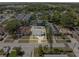 A street view of a residential area, showcasing the home's location surrounded by mature trees and other houses at 4408 W Prescott St, Tampa, FL 33616