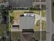 A detailed aerial view of the home featuring a backyard with a storage shed and an extended driveway at 4408 W Prescott St, Tampa, FL 33616