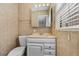Traditional bathroom features a single sink, vanity, toilet, and window at 4408 W Prescott St, Tampa, FL 33616