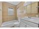 Classic bathroom featuring tiled walls, shower-tub combo, and modern vanity sink at 4408 W Prescott St, Tampa, FL 33616