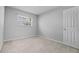 An empty bedroom with carpeted floors and a window that provides natural light at 4408 W Prescott St, Tampa, FL 33616