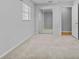 This bedroom features neutral carpet, ample closet space, and natural light from the window at 4408 W Prescott St, Tampa, FL 33616