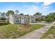 Attractive single-story house showcasing arched windows, and a concrete pathway leading to the front door at 4408 W Prescott St, Tampa, FL 33616