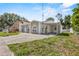 Charming home exterior with a well-maintained lawn and unique architectural details including arched windows at 4408 W Prescott St, Tampa, FL 33616