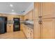 Well-lit kitchen features oak cabinets, black appliances, and laminate countertops at 4408 W Prescott St, Tampa, FL 33616