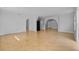 Spacious empty living room featuring tile floors, neutral walls, and arched doorways leading to other rooms at 4408 W Prescott St, Tampa, FL 33616