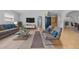 Bright living room with neutral decor, tile flooring, and ample natural light; virtually staged at 4408 W Prescott St, Tampa, FL 33616