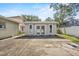 Exterior of a detached shed featuring double doors and windows, set on a concrete slab in a backyard at 4408 W Prescott St, Tampa, FL 33616