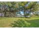 Serene backyard with lush lawn, mature trees, and tranquil lake view offering a peaceful outdoor retreat at 5151 Puritan Cir # 1022, Tampa, FL 33617