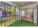 View of the screened balcony with a kitchen view and tropical landscaping at 5151 Puritan Cir # 1022, Tampa, FL 33617