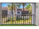 View from screened balcony of a grassy and tropical backyard area at 5151 Puritan Cir # 1022, Tampa, FL 33617